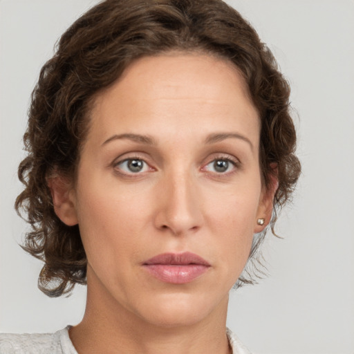 Joyful white young-adult female with medium  brown hair and green eyes