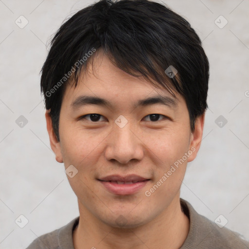 Joyful asian young-adult male with short  brown hair and brown eyes