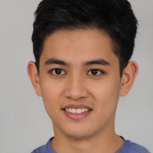 Joyful asian young-adult male with short  black hair and brown eyes