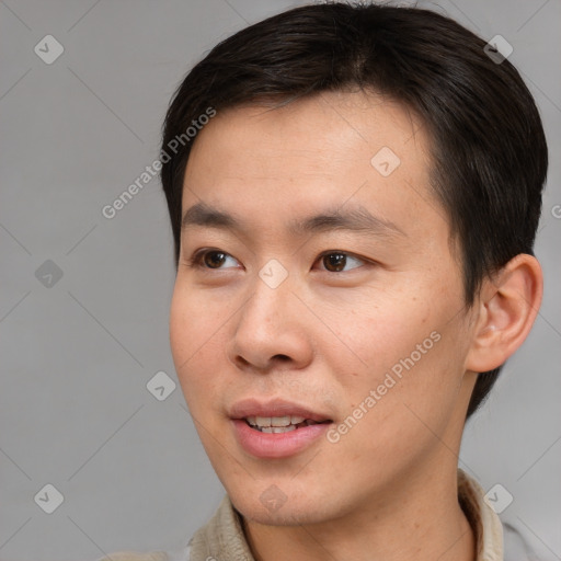 Joyful asian young-adult male with short  brown hair and brown eyes