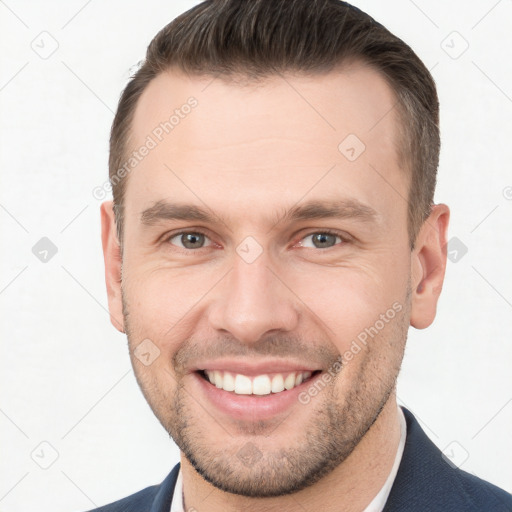 Joyful white young-adult male with short  brown hair and brown eyes