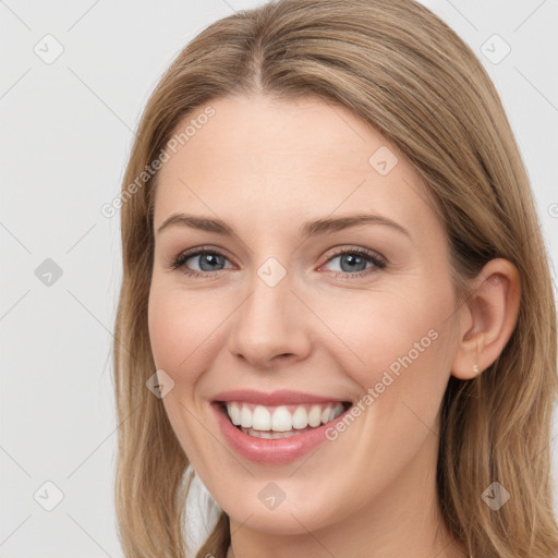 Joyful white young-adult female with long  brown hair and grey eyes