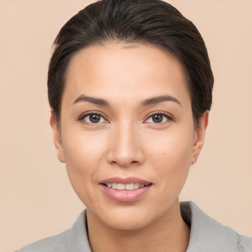 Joyful white young-adult female with short  brown hair and brown eyes