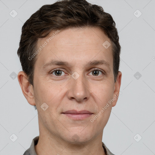 Joyful white adult male with short  brown hair and brown eyes