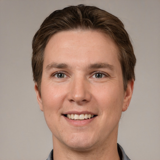 Joyful white adult male with short  brown hair and grey eyes