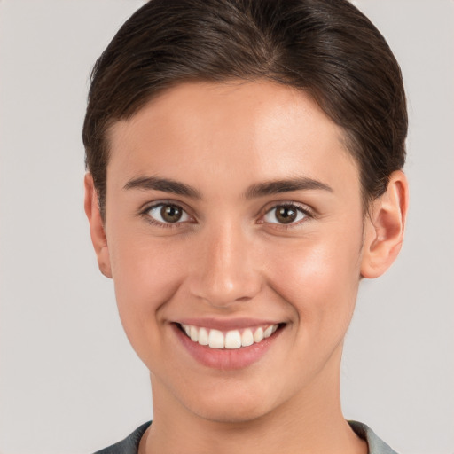 Joyful white young-adult female with short  brown hair and brown eyes