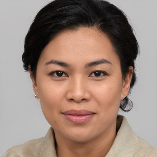 Joyful asian young-adult female with medium  brown hair and brown eyes