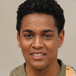 Joyful black young-adult male with short  black hair and brown eyes