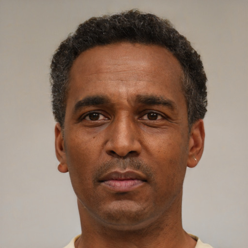 Neutral latino adult male with short  black hair and brown eyes