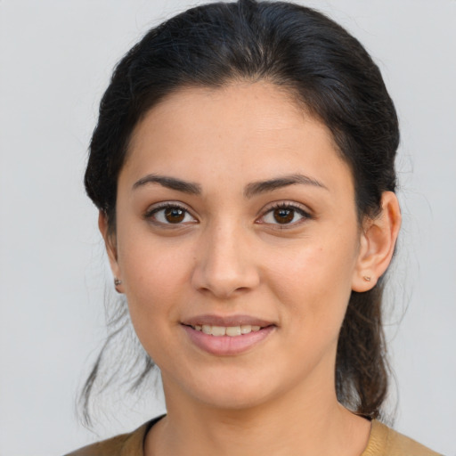 Joyful latino young-adult female with medium  brown hair and brown eyes
