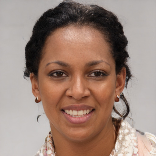Joyful black young-adult female with medium  brown hair and brown eyes