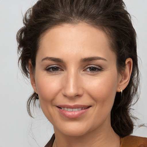 Joyful white young-adult female with medium  brown hair and brown eyes