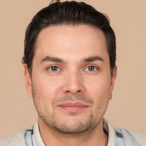 Joyful white adult male with short  brown hair and brown eyes