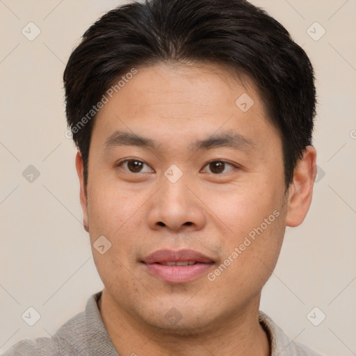 Joyful asian young-adult male with short  brown hair and brown eyes