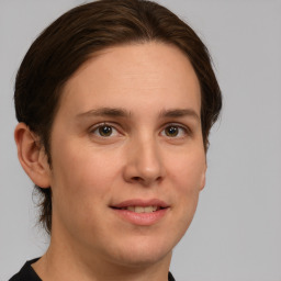 Joyful white young-adult female with medium  brown hair and green eyes