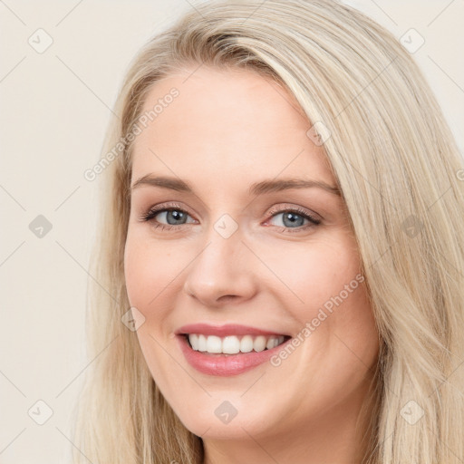 Joyful white young-adult female with long  brown hair and blue eyes