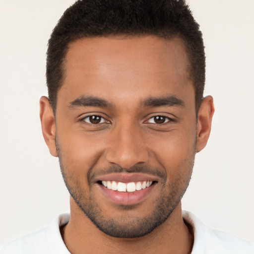 Joyful black young-adult male with short  brown hair and brown eyes