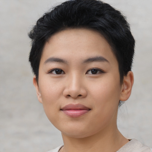 Joyful asian young-adult female with short  black hair and brown eyes
