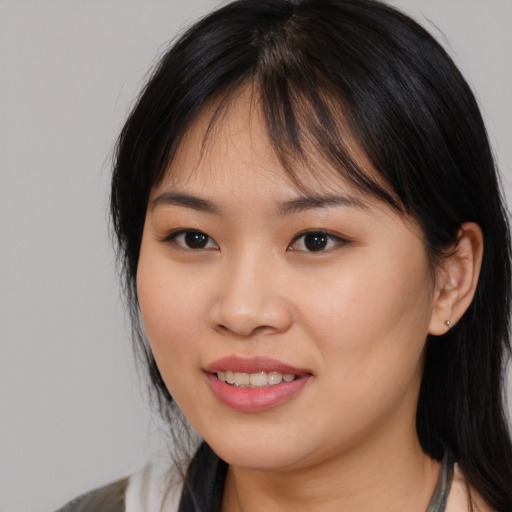 Joyful asian young-adult female with medium  brown hair and brown eyes