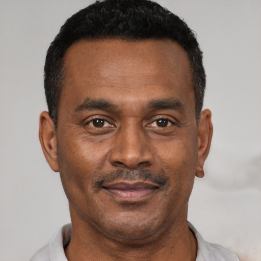 Joyful latino adult male with short  black hair and brown eyes
