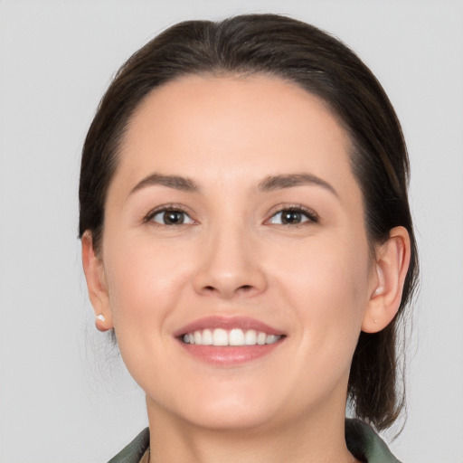 Joyful white young-adult female with medium  brown hair and brown eyes