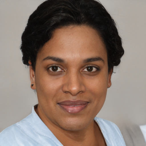 Joyful latino young-adult female with short  black hair and brown eyes
