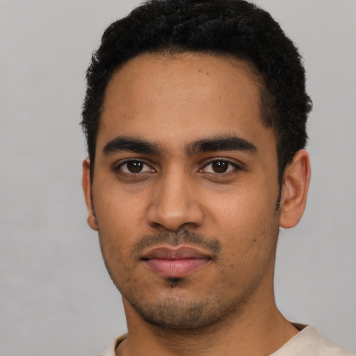 Neutral latino young-adult male with short  black hair and brown eyes