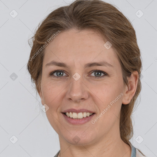 Joyful white adult female with medium  brown hair and grey eyes