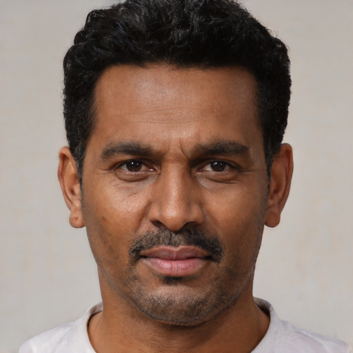 Neutral latino adult male with short  black hair and brown eyes