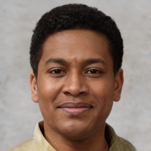 Joyful black young-adult male with short  black hair and brown eyes