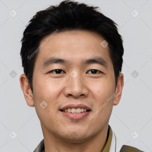 Joyful asian young-adult male with short  black hair and brown eyes