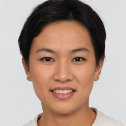 Joyful asian young-adult female with short  brown hair and brown eyes