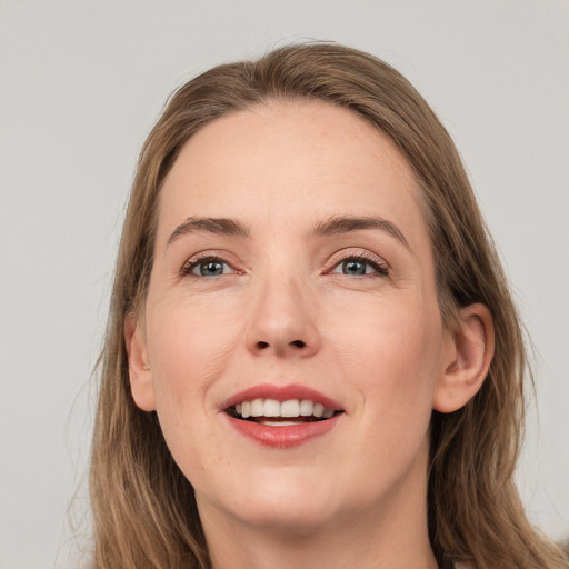 Joyful white young-adult female with long  brown hair and grey eyes