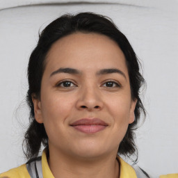 Joyful latino young-adult female with medium  brown hair and brown eyes