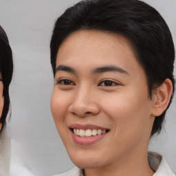 Joyful asian young-adult female with short  black hair and brown eyes