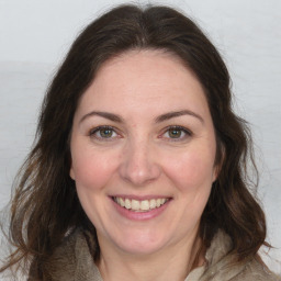 Joyful white adult female with medium  brown hair and brown eyes