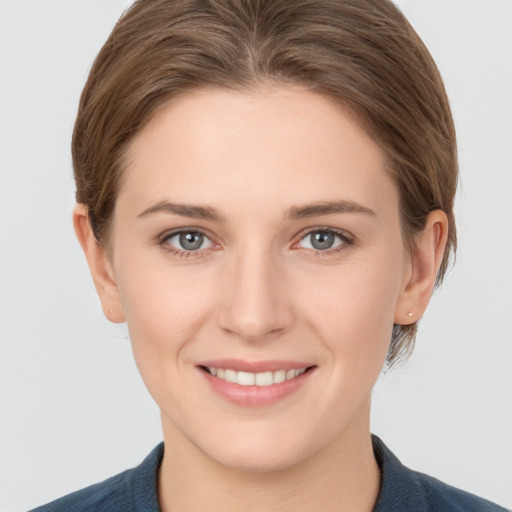 Joyful white young-adult female with short  brown hair and grey eyes