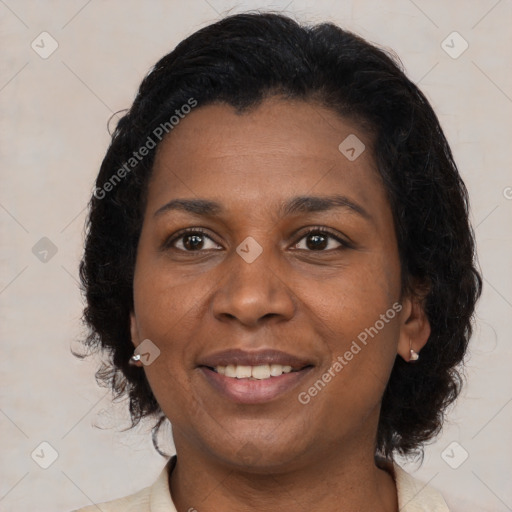 Joyful black adult female with medium  brown hair and brown eyes