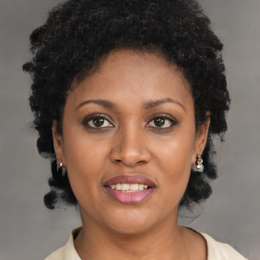 Joyful black young-adult female with short  brown hair and brown eyes