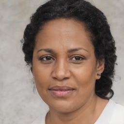 Joyful black adult female with medium  brown hair and brown eyes