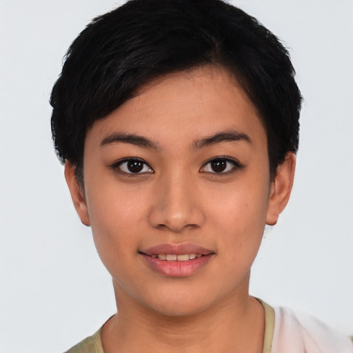 Joyful latino young-adult female with short  black hair and brown eyes