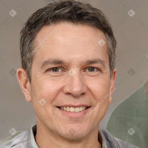 Joyful white adult male with short  brown hair and brown eyes