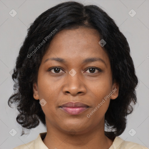 Joyful black adult female with medium  brown hair and brown eyes