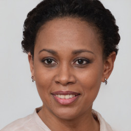 Joyful black young-adult female with short  brown hair and brown eyes