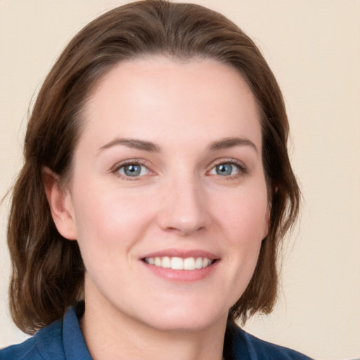 Joyful white young-adult female with medium  brown hair and blue eyes