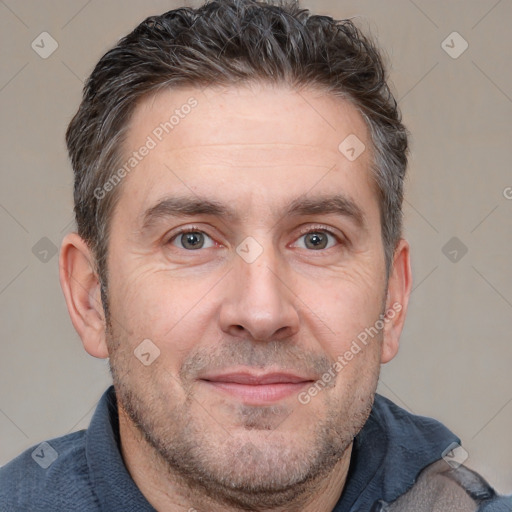 Joyful white adult male with short  brown hair and brown eyes