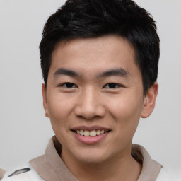 Joyful asian young-adult male with short  black hair and brown eyes