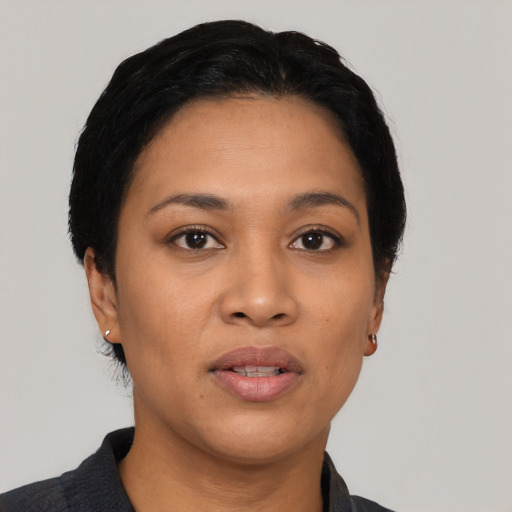 Joyful latino young-adult female with short  black hair and brown eyes