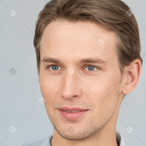 Joyful white young-adult male with short  brown hair and brown eyes