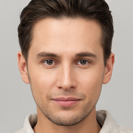 Joyful white young-adult male with short  brown hair and brown eyes